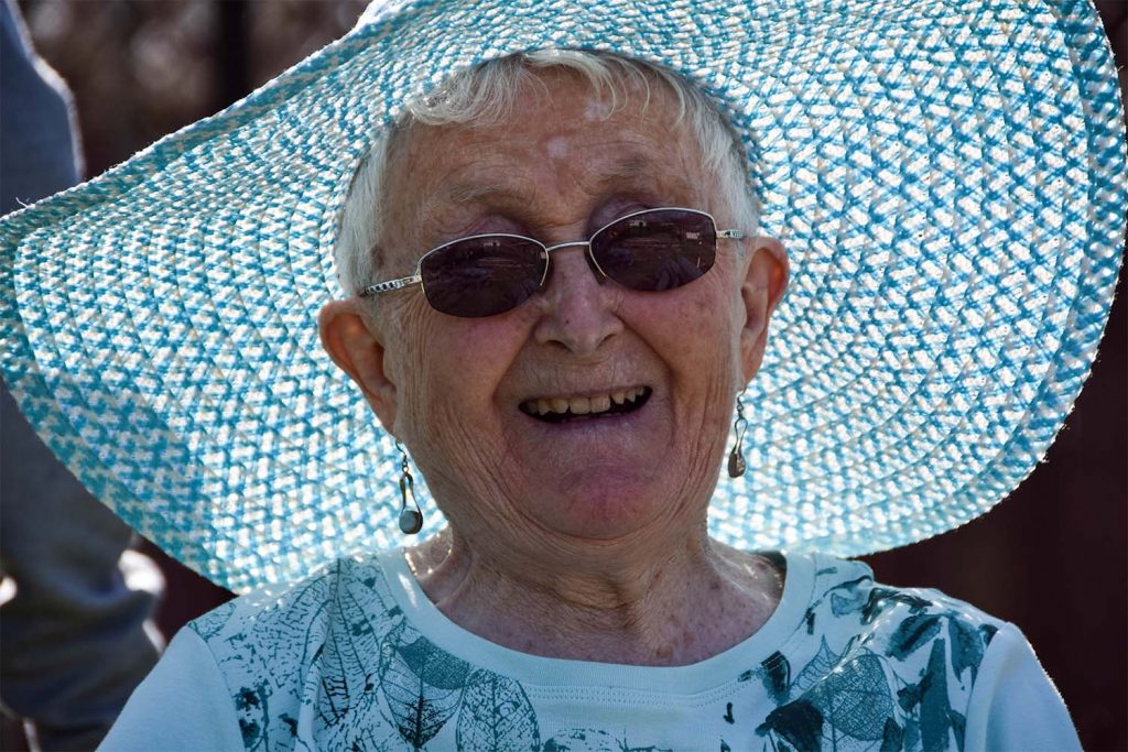 Resident with blue hat smiling
