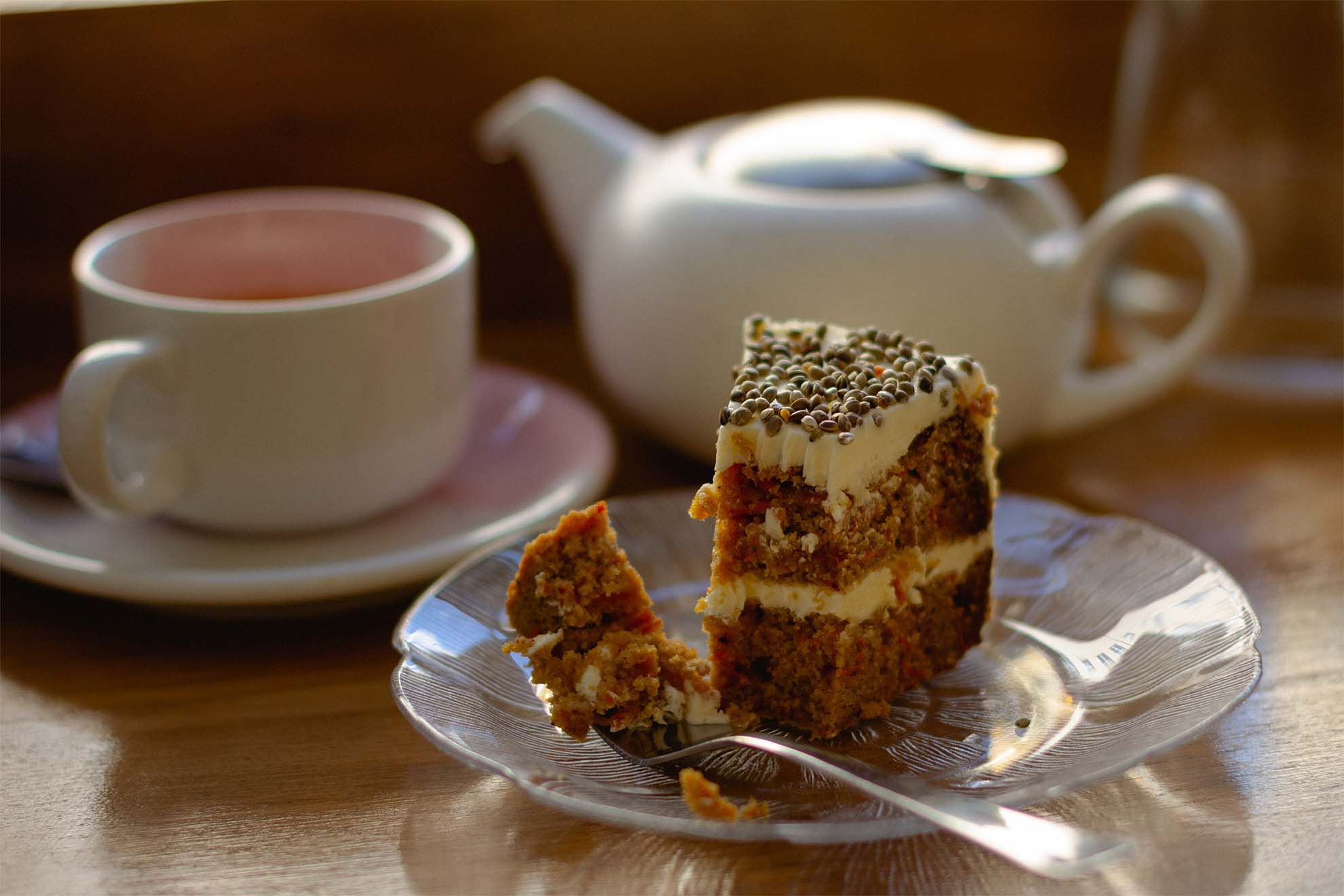 Cake on a plate with a pot of tea