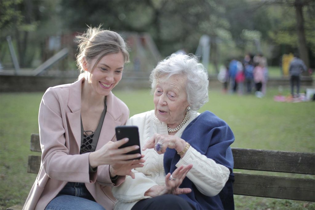 Resident looking at phone with family