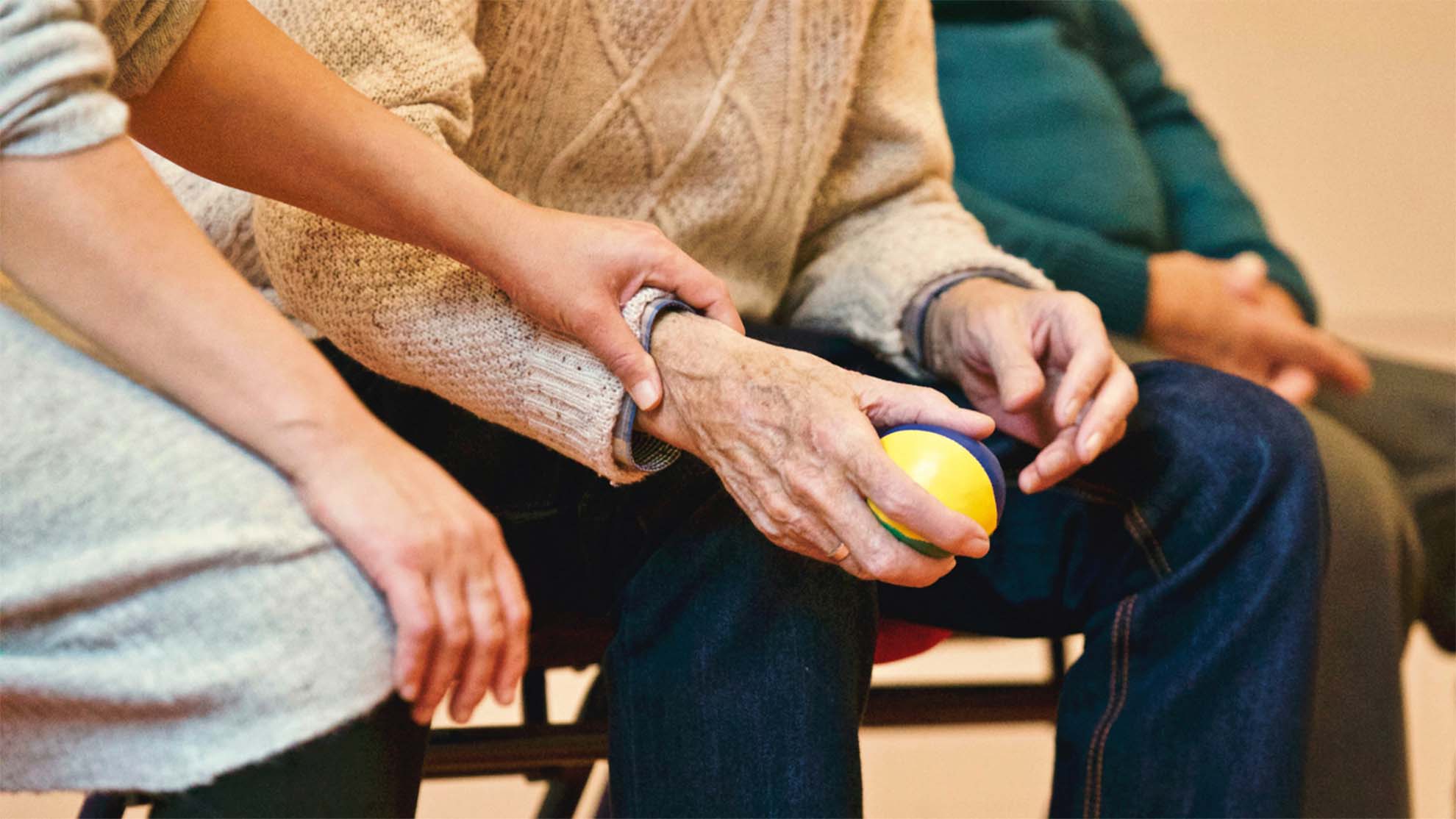 Carer helping resident with ball