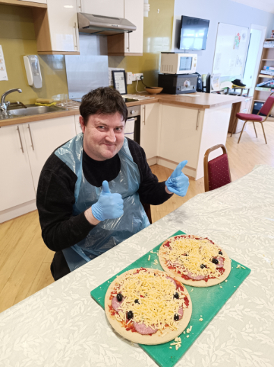 Resident making a pizza in the kitchen